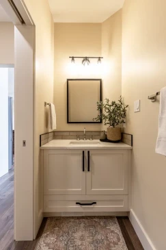 Modern bathroom vanity with custom cabinetry, quartz countertop, and stylish lighting in an RTM home.