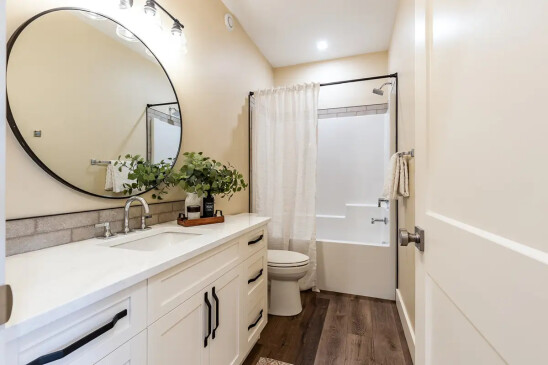 Bright full bathroom in a Ready to Move home with modern vanity, bathtub, and contemporary finishes.