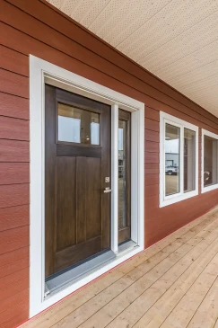 Covered front porch and custom wood front door of a Ready to Move home built by Jade Homes.