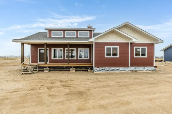 Custom RTM home with covered front porch and modern exterior built by Jade Homes for delivery in Saskatchewan.