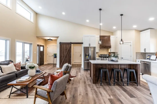 Open concept RTM home featuring a spacious kitchen, living room, and dining area with modern finishes.