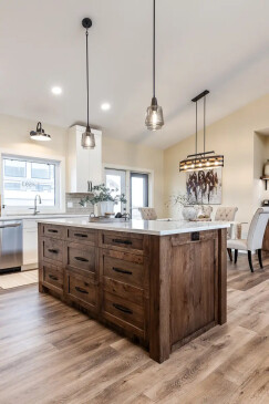 Custom kitchen in a Ready to Move home with a large island, quartz countertops, and rustic wood cabinetry.