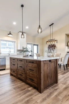 Custom kitchen in a Ready to Move home with a large island, quartz countertops, and rustic wood cabinetry.