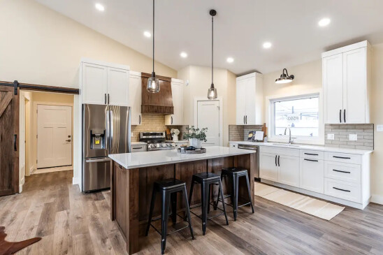 Modern RTM home kitchen featuring custom cabinetry, stainless steel appliances, and a spacious island.