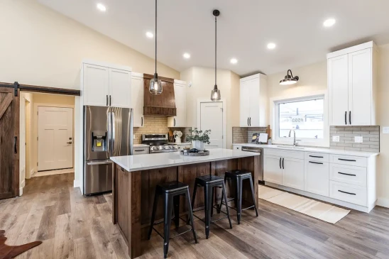 Modern RTM home kitchen featuring custom cabinetry, stainless steel appliances, and a spacious island.