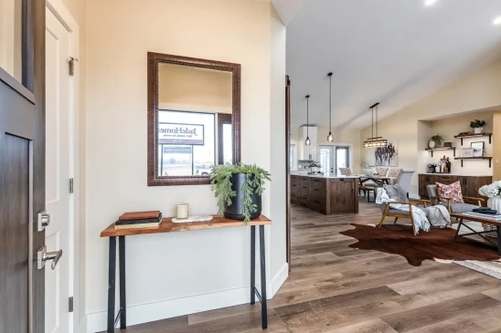 View from the front entry into an open concept Ready to Move home with custom finishes and natural light.