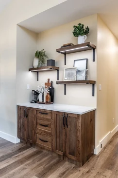 Custom coffee bar with floating shelves and built in cabinetry in a modern RTM home.