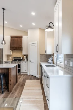 Bright custom kitchen in a Ready to Move home with white cabinetry, quartz countertops, and ample workspace.