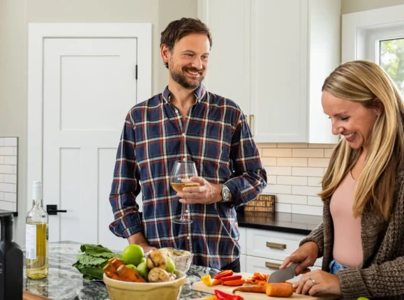 Homeowners enjoying modern kitchen inside RTM home with large island and open concept layout in Alberta and Saskatchewan