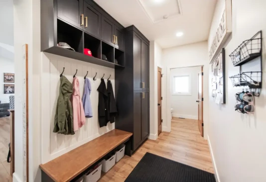 Functional mudroom with built in lockers, bench seating, overhead storage, and custom cabinetry.