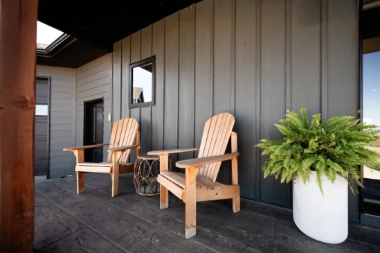 Inviting covered front porch with timber posts, composite decking, and comfortable outdoor seating.