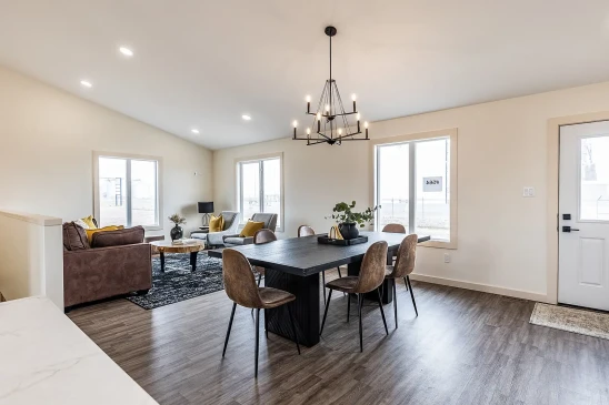 Spacious open concept RTM home with dining area, large windows and modern lighting in Alberta and Saskatchewan