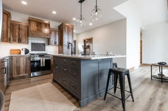 Custom kitchen in RTM home with large island, quartz countertops and wood cabinetry in Alberta and Saskatchewan