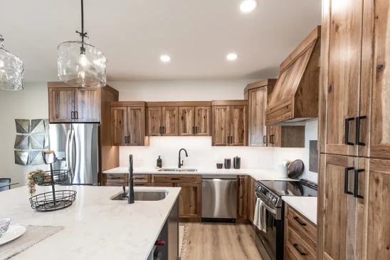 Custom wood kitchen cabinetry with stainless steel appliances in modern RTM home in Alberta and Saskatchewan
