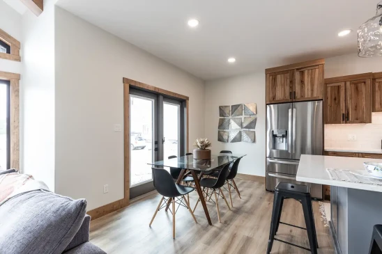 Dining space in modern RTM home with glass patio doors and open layout in Alberta and Saskatchewan