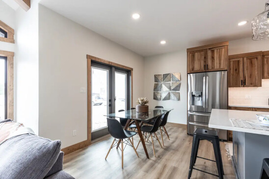 Dining space in modern RTM home with glass patio doors and open layout in Alberta and Saskatchewan