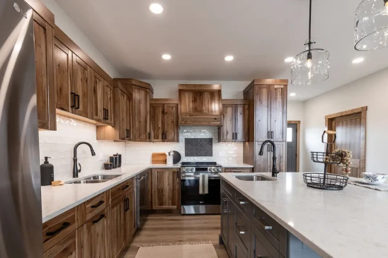 Spacious RTM home kitchen with custom wood cabinets, stainless steel appliances and quartz counters in Alberta and Saskatchewan