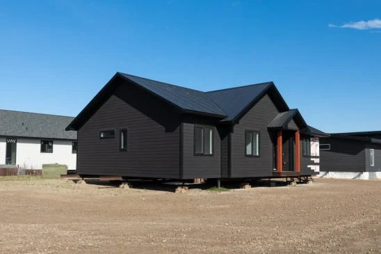 Angled exterior view of a custom Ready to Move home with durable siding and contemporary design.