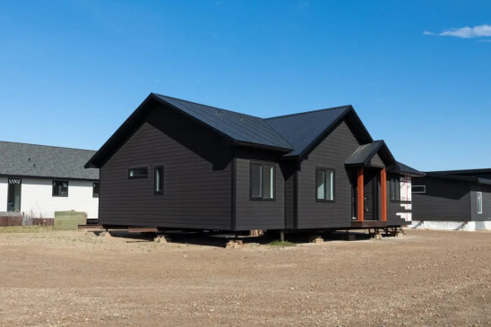 Angled exterior view of a custom Ready to Move home with durable siding and contemporary design.