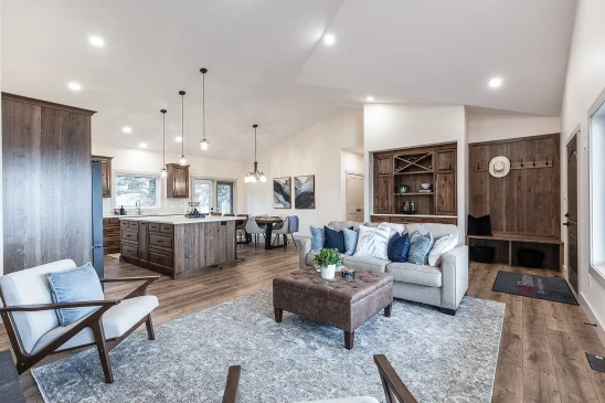 Open concept RTM home with living room, custom kitchen island and built-in cabinetry