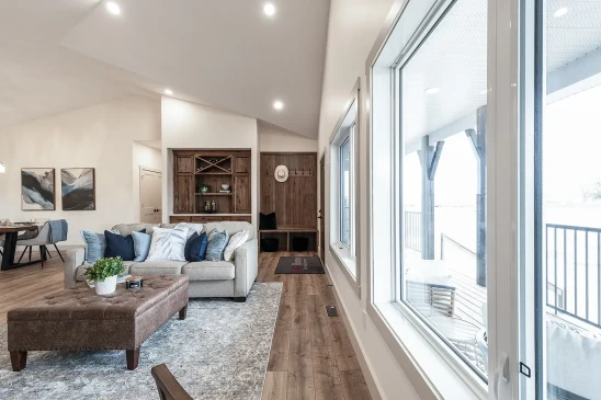 Bright RTM living space with large energy-efficient windows and vaulted ceiling