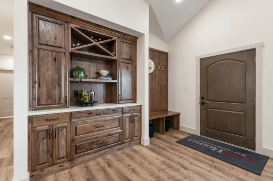 Rustic wood built-in hutch with wine rack and soft-close drawers in ready-to-move home