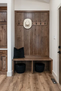 RTM mudroom bench with wood panel feature wall and coat hooks